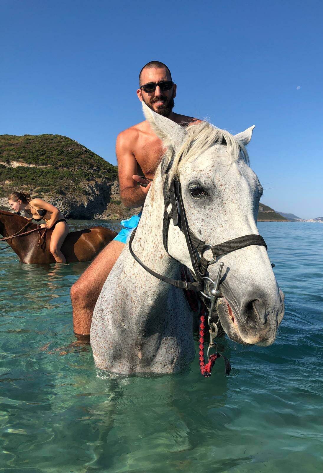 Clément Rebuffel on a horse, in the sea in Corsica